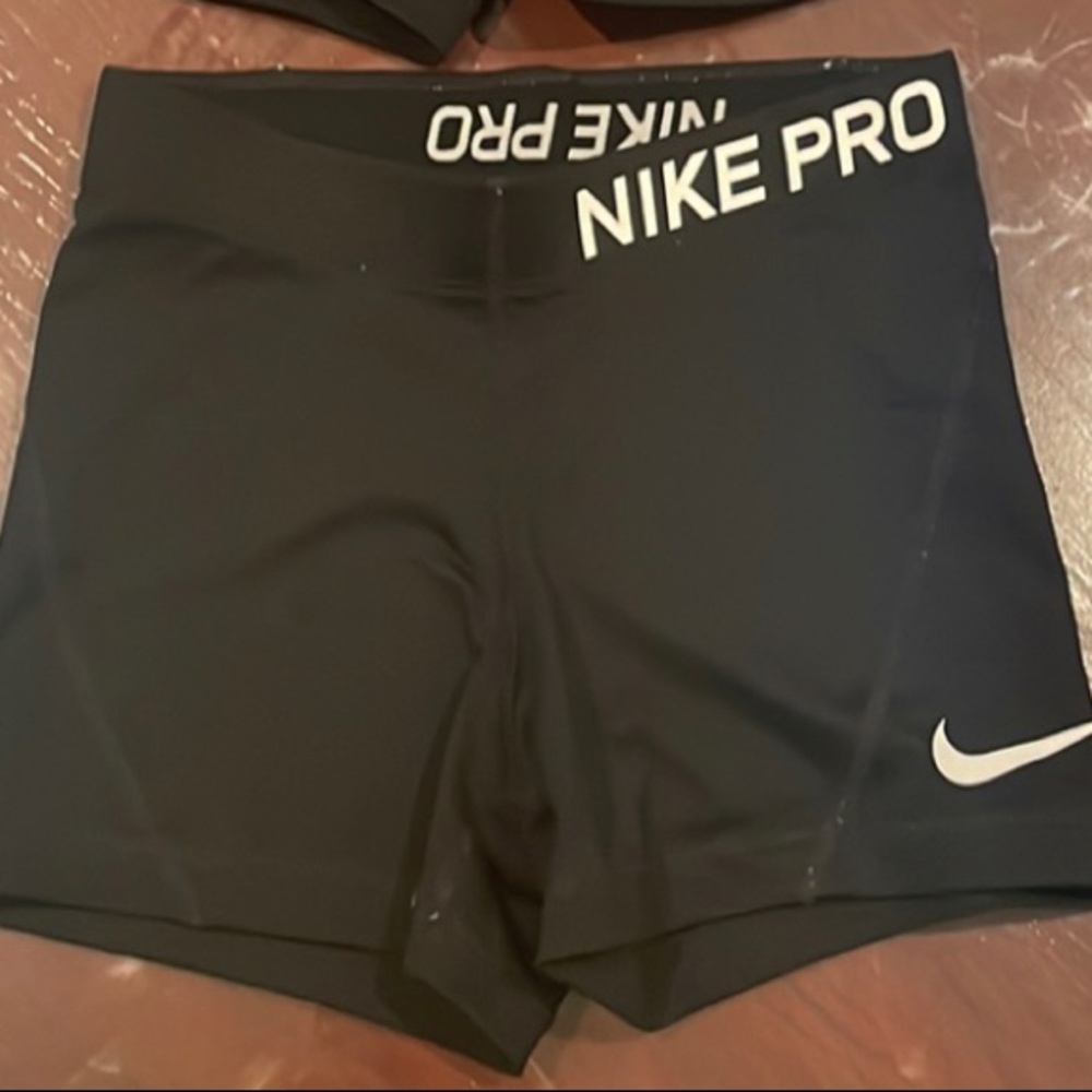 One all black and one teal nike pro shorts